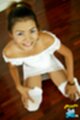 Katie squatting on floor looking up hands on her knees