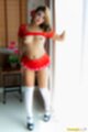 Baifern standing in doorway top raised over her small tits in short skirt wearing knee high stockings in high heels