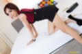 Sofia kneeling on bed