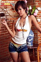  wearing white top denim shorts playing with necklace