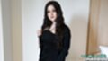 Wearing black dress long hair falling over her shoulders